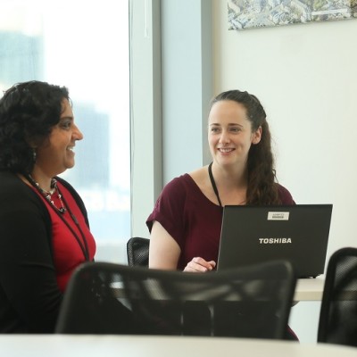 Two people talking at work