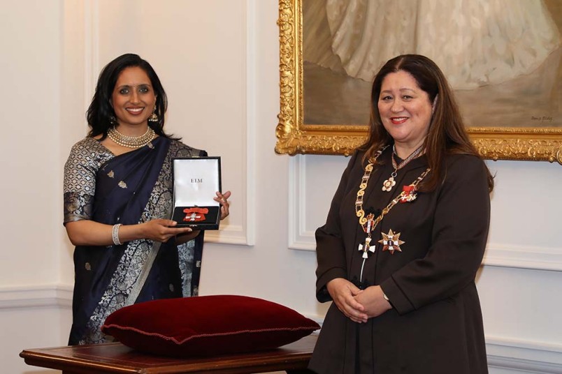 The Rt Hon Dame Cindy Kiro, Governor-General investing Vanisa Dhiru with her insignia as a Member of the New Zealand Order of Merit, recognising her services to the community and gender rights.